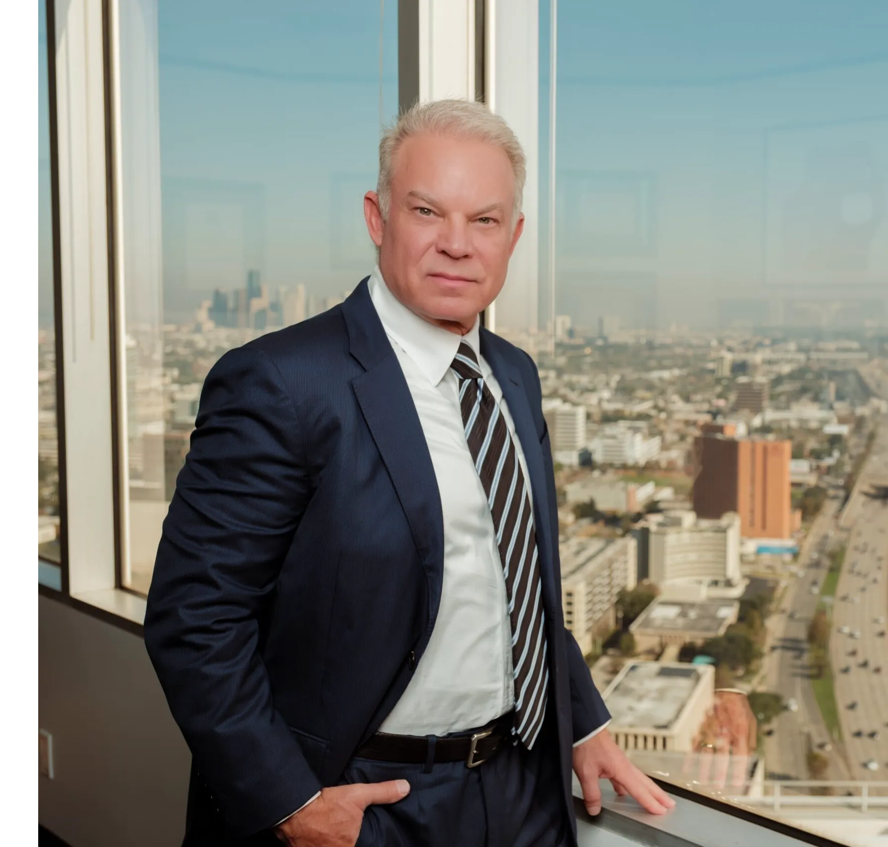 James Lassiter at a window with a view of Houston